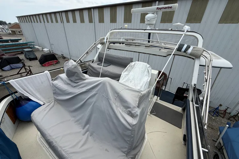 Slide: The Image of 1988 Carver 38 Aft Cabin Motor Yacht with covered seating and radar equipment. - 14