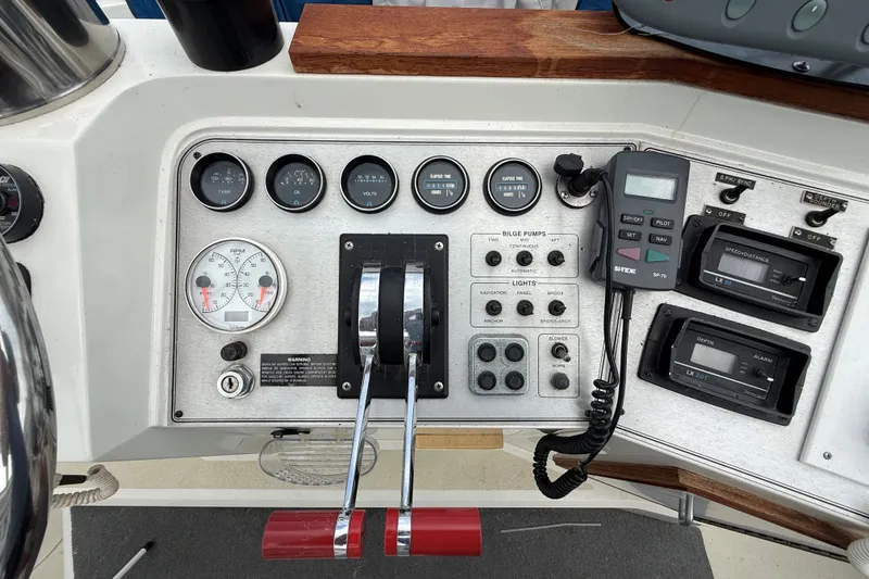 Slide: The Image of Control panel of a 1988 Carver 38 Aft Cabin Motor Yacht with gauges and switches. - 18