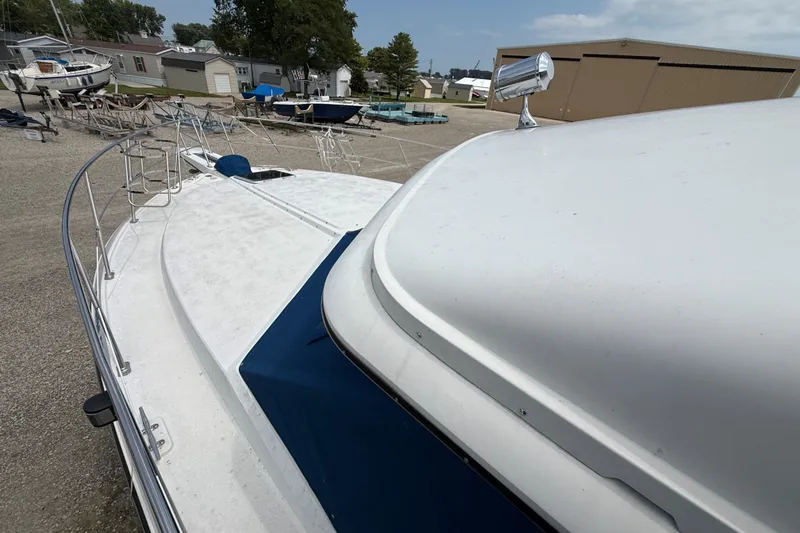 Slide: The Image of 1988 Carver 38 Aft Cabin Motor Yacht on dry dock, showcasing deck and railing. - 8