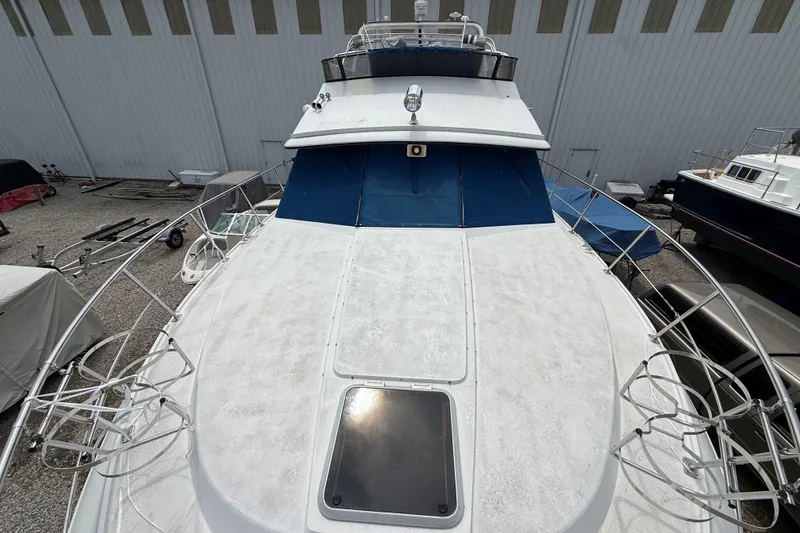 Slide: The Image of 1988 Carver 38 Aft Cabin Motor Yacht docked, showcasing spacious deck and sleek design. - 9