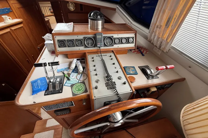 Slide: The Image of 1988 Carver 38 Aft Cabin Motor Yacht helm with controls and gauges. - 26