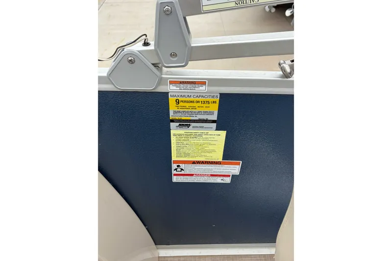 Slide: The Image of 2017 Premier 200 Explorer capacity label, maximum 9 persons or 1375 lbs, safety warnings. - 6