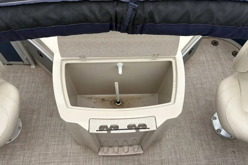 Slide: The Image of Open storage compartment on 2017 Premier 200 Explorer boat with beige seating. - 7