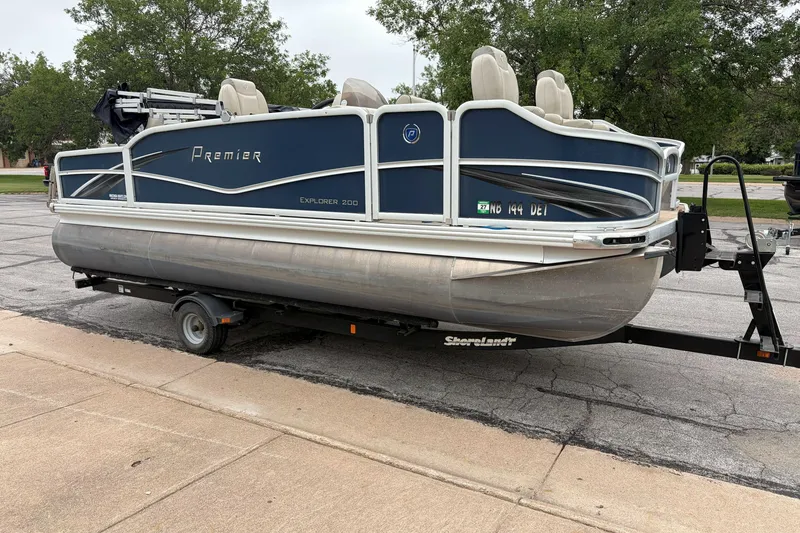 The Image of 2017 Premier 200 Explorer pontoon boat on trailer, parked outdoors. - 0