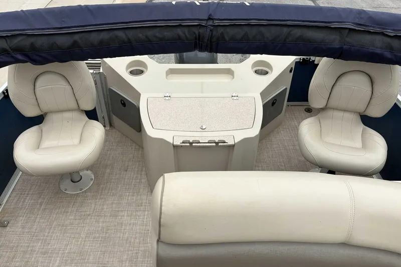 Slide: The Image of Interior of a 2017 Premier 200 Explorer boat with beige seating and console. - 8