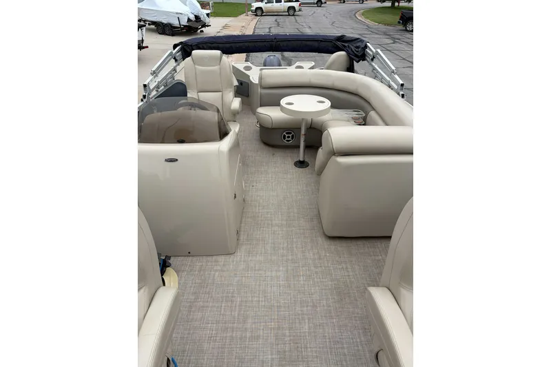 Slide: The Image of 2017 Premier 200 Explorer boat interior with beige seating and a small table. - 4