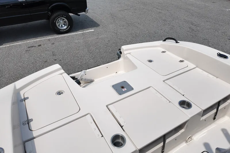 Slide: The Image of 2027 Carolina Skiff 22 Ultra Elite boat interior with storage compartments and cup holders. - 5