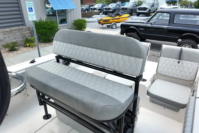 Slide: The Image of 2027 Carolina Skiff 22 Ultra Elite boat interior with gray seating and modern design. - 12