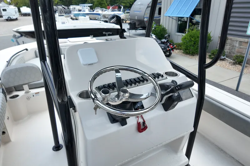 Slide: The Image of 2027 Carolina Skiff 22 Ultra Elite boat console with steering wheel and controls. - 13