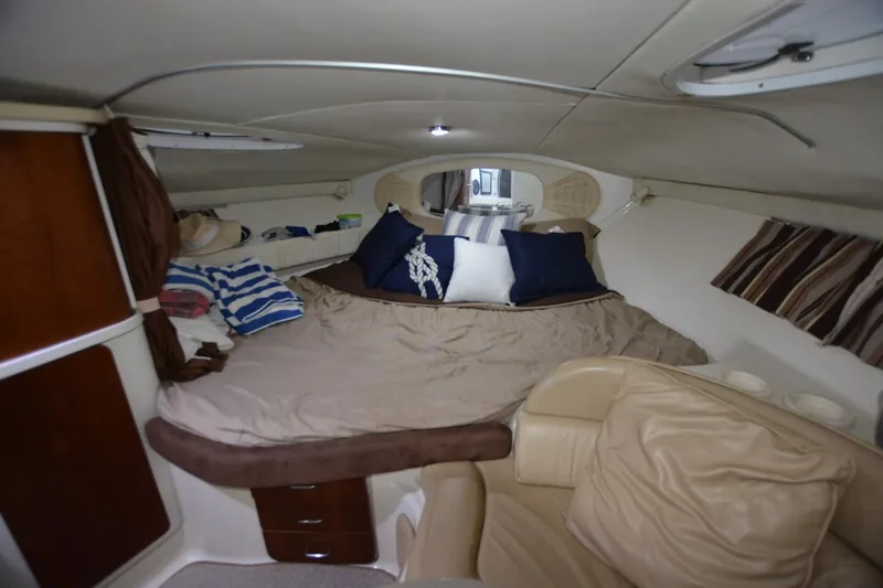 Slide: The Image of Interior cabin of 2001 Chris-Craft 328 Express Cruiser with cozy bedding and seating. - 11