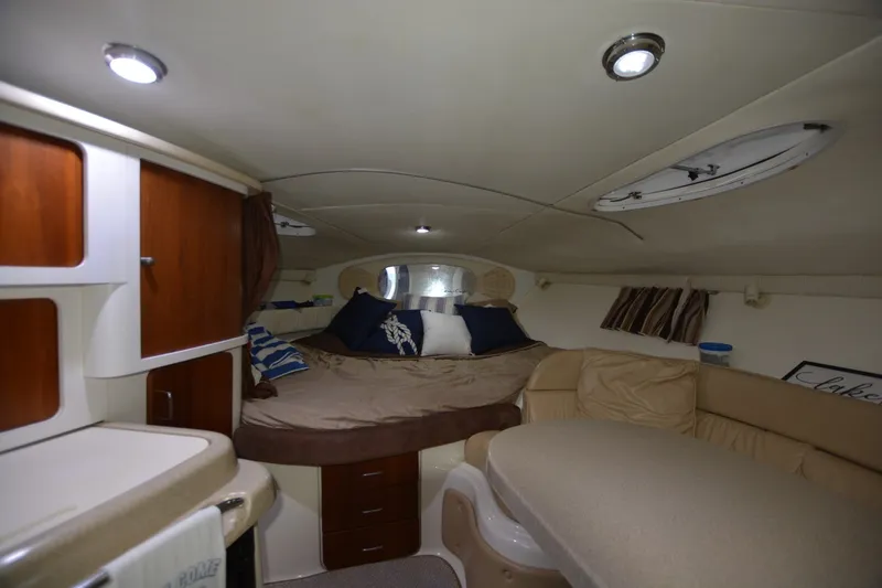 Slide: The Image of Interior of 2001 Chris-Craft 328 Express Cruiser with cozy seating and elegant wood cabinetry. - 7