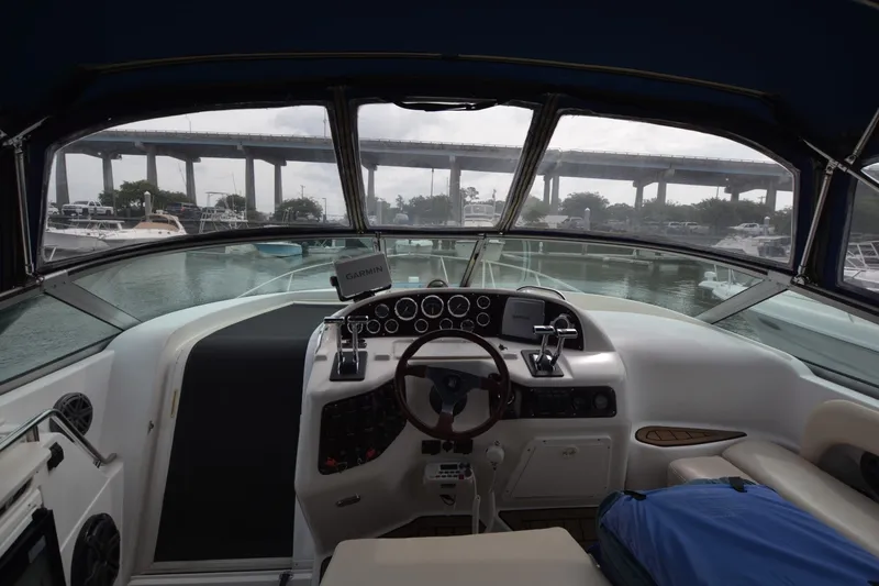 Slide: The Image of 2001 Chris-Craft 328 Express Cruiser cockpit with steering wheel and navigation equipment. - 5