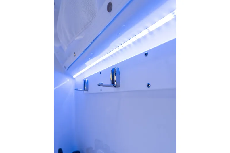 Slide: The Image of LED-lit interior detail of 2027 Sea Hunt Ultra 305SL boat, showcasing sleek design elements. - 31