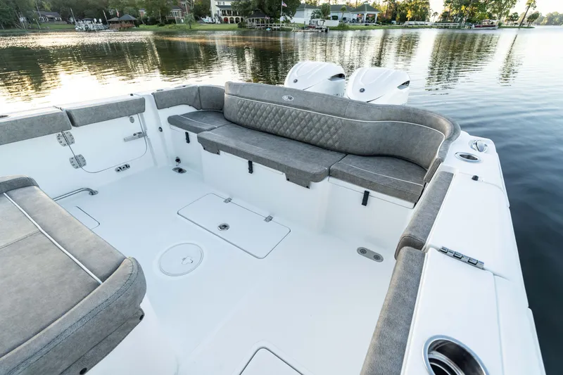 Slide: The Image of 2027 Sea Hunt Ultra 305SL boat interior with spacious seating on calm water. - 18