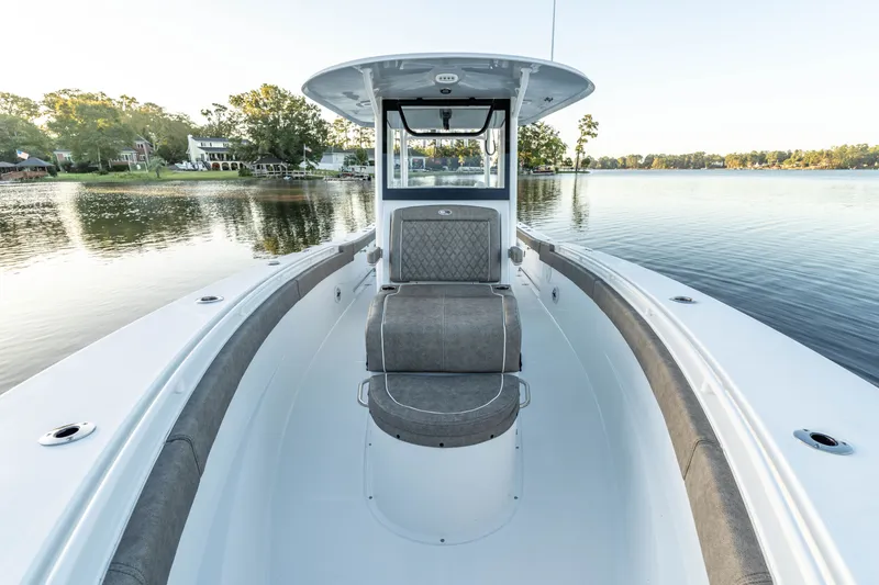 Slide: The Image of 2027 Sea Hunt Ultra 305SL boat on calm lake, featuring spacious seating and sleek design. - 20