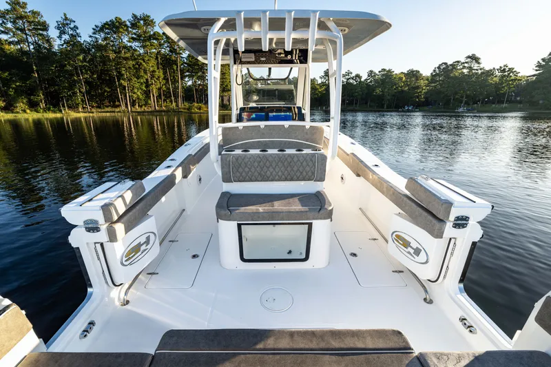 Slide: The Image of 2027 Sea Hunt Ultra 305SL boat interior on a serene lake. - 26