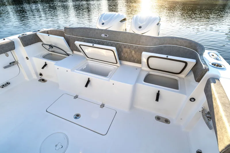 Slide: The Image of 2027 Sea Hunt Ultra 305SL boat interior with open storage compartments and dual engines. - 25
