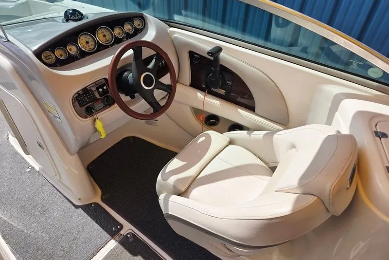 Slide: The Image of 2005 Chaparral Sunesta 254 boat cockpit with steering wheel and control panel. - 13