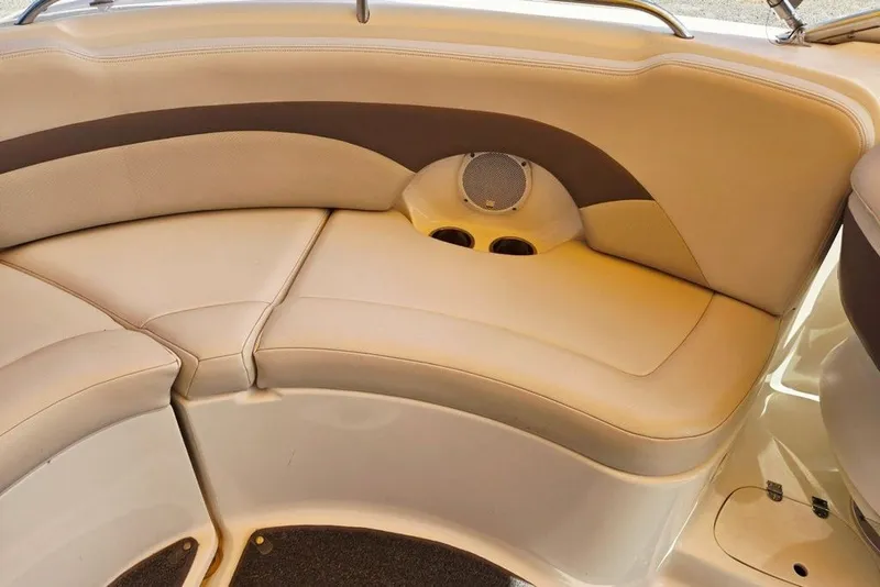 Slide: The Image of 2005 Chaparral Sunesta 254 boat interior with beige seating and built-in speaker. - 23