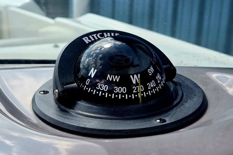 Slide: The Image of Compass on 2005 Chaparral Sunesta 254 boat dashboard, showing northwest direction. - 19