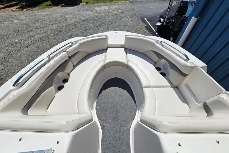 Slide: The Image of 2005 Chaparral Sunesta 254 boat interior with white seating and cup holders. - 10