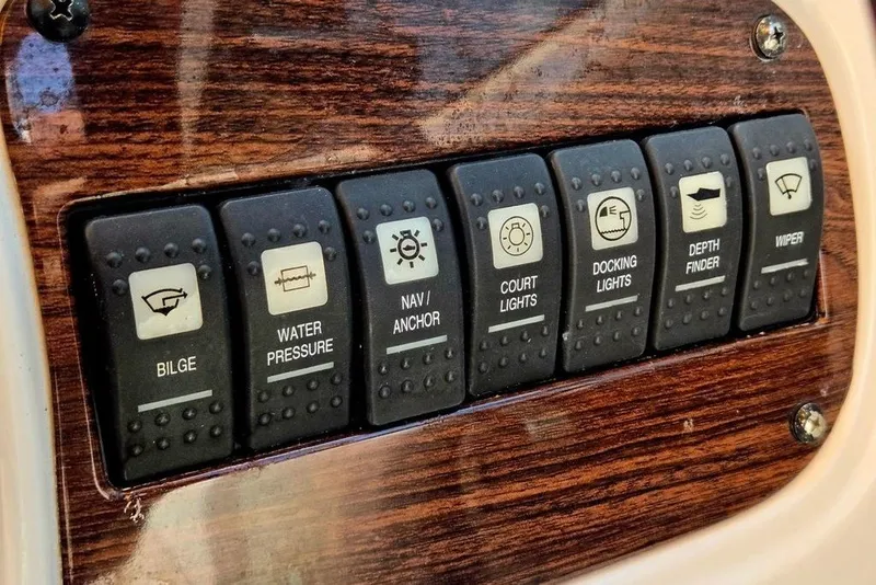 Slide: The Image of Control panel of a 2005 Chaparral Sunesta 254 boat with various switches. - 5