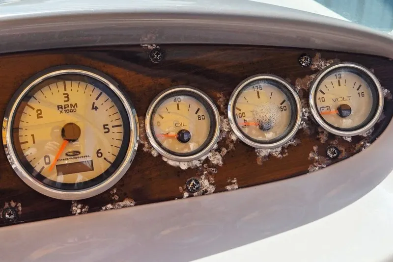 Slide: The Image of Dashboard gauges of a 2005 Chaparral Sunesta 254 boat, showing RPM, oil, temperature, and voltage. - 21