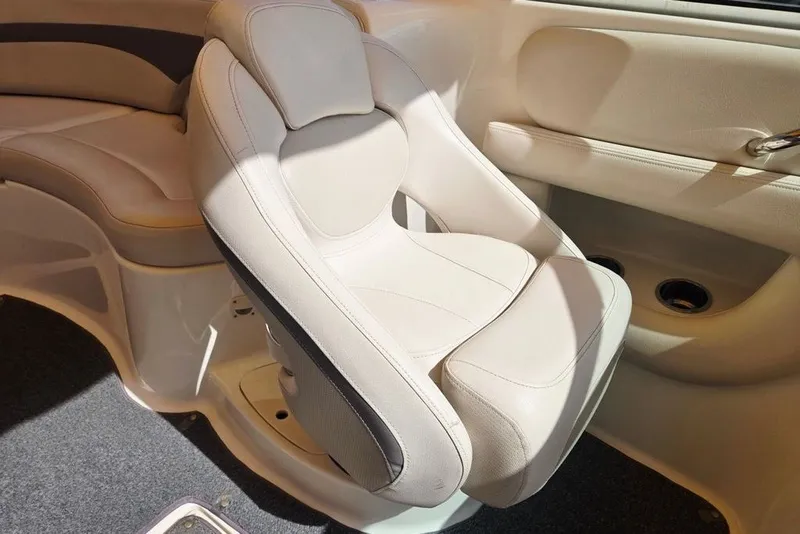 Slide: The Image of 2005 Chaparral Sunesta 254 boat interior with beige seating and carpeted flooring. - 15