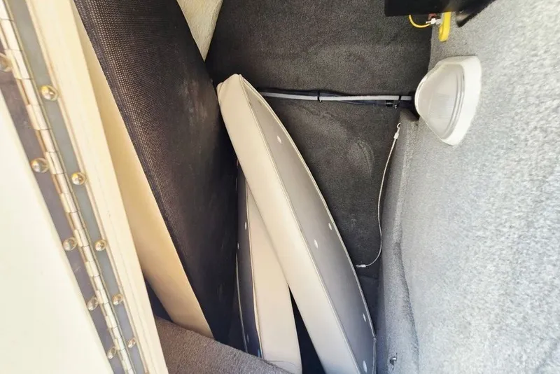 Slide: The Image of Storage compartment in a 2005 Chaparral Sunesta 254 boat with cushions and speaker. - 22