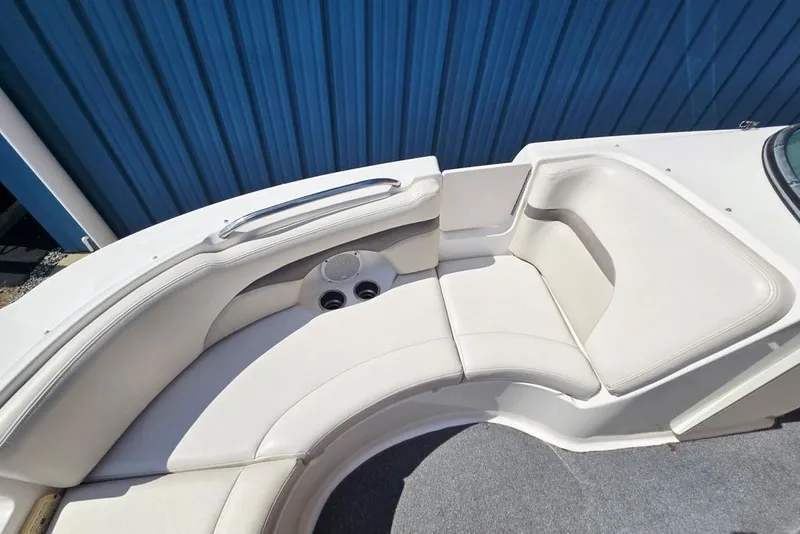 Slide: The Image of 2005 Chaparral Sunesta 254 boat interior with white seating and cup holders. - 28