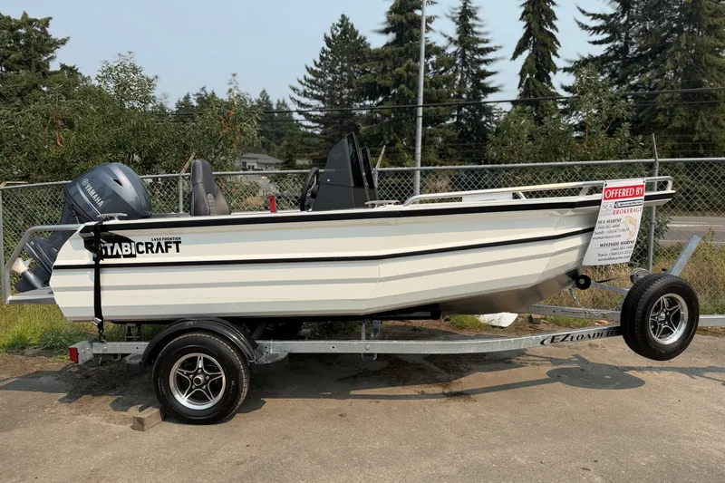 The Image of 2025 Stabicraft 1450 Explorer boat on trailer, parked outdoors. - 1