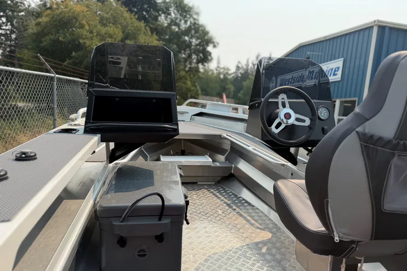 Slide: The Image of 2025 Stabicraft 1450 Explorer interior with steering wheel and seating, showcasing modern design. - 2