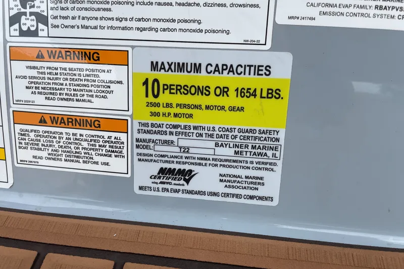 Slide: The Image of Warning labels and capacity information on a 2024 Trophy CC22 boat. - 8