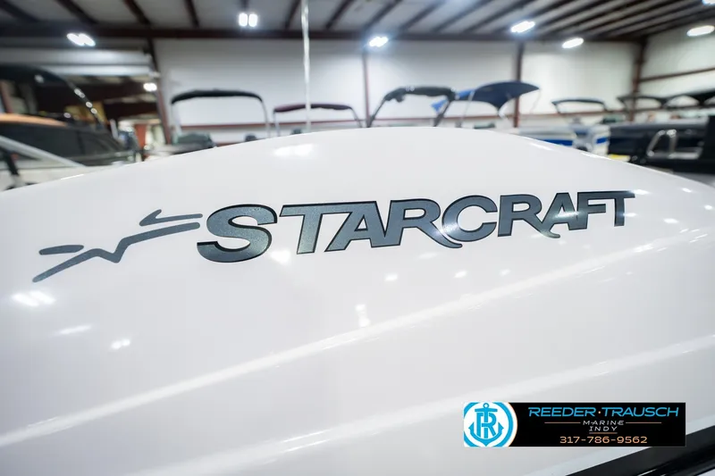 Slide: The Image of 2006 Starcraft C-Star 1700 I/O F&S boat in showroom, featuring bold logo. - 52