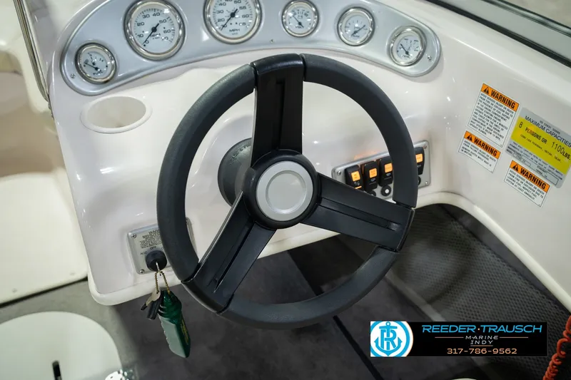 Slide: The Image of 2006 Starcraft C-Star 1700 I/O F&S boat dashboard with steering wheel and gauges. - 33