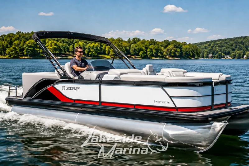 The Image of 2026 Godfrey Sweetwater 2286 SBC pontoon boat cruising on a scenic lake. - 0
