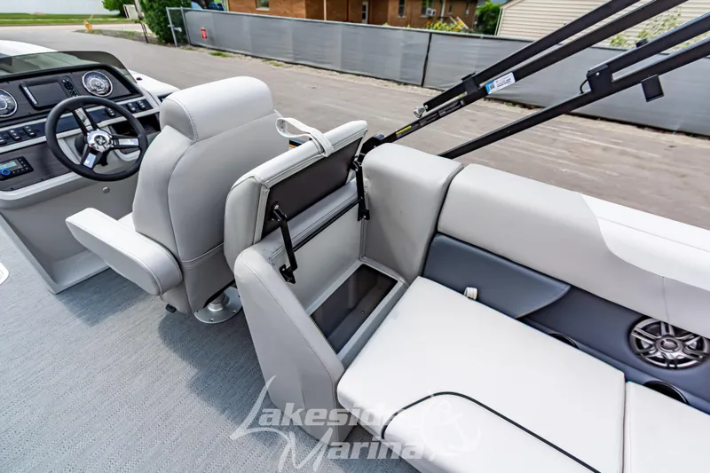Slide: The Image of 2026 Godfrey Sweetwater 2286 SBC boat interior with steering console and seating area. - 19