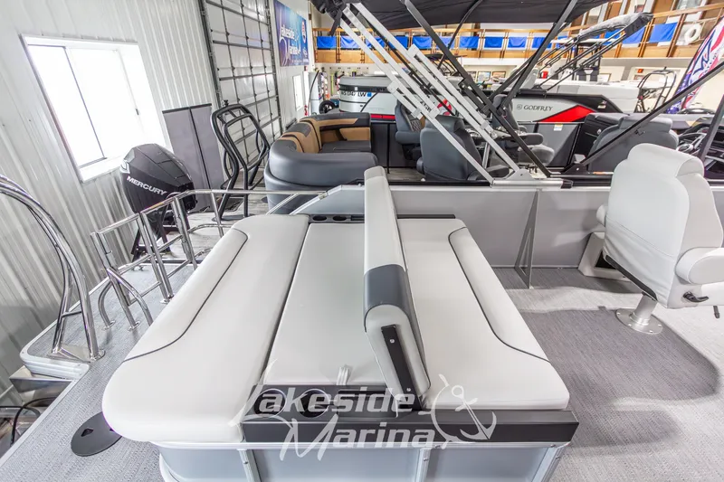 Slide: The Image of 2026 Godfrey Monaco 235 SFLC pontoon boat interior with seating and Mercury engine. - 22