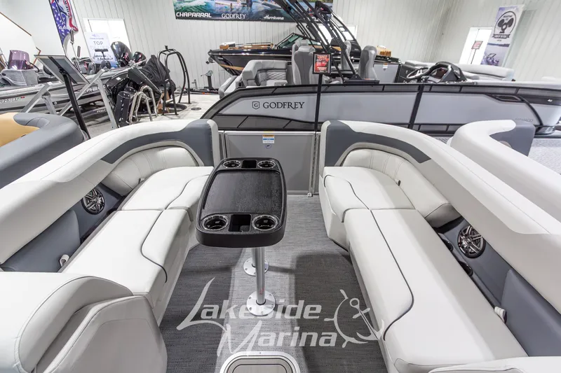 Slide: The Image of 2026 Godfrey Monaco 235 SFLC pontoon boat interior with luxurious seating and table. - 5