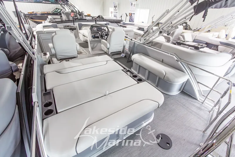 Slide: The Image of 2026 Godfrey Monaco 235 SFLC pontoon boat interior with luxurious seating and modern dashboard. - 27