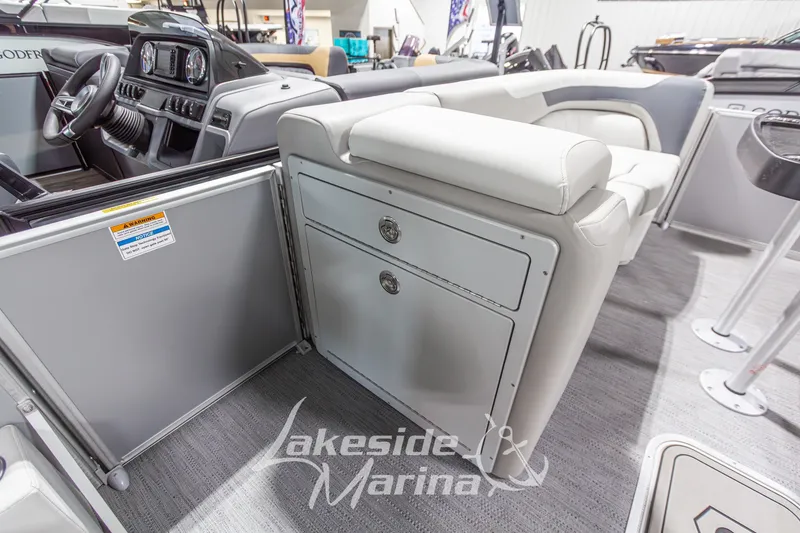 Slide: The Image of Interior of 2026 Godfrey Monaco 235 SFLC boat with seating and storage, Lakeside Marina branding. - 12