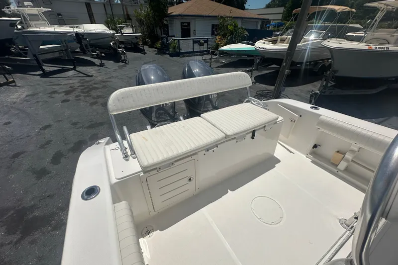 Slide: The Image of 2005 Cobia 254 Center Console boat with dual outboard motors in a marina setting. - 14