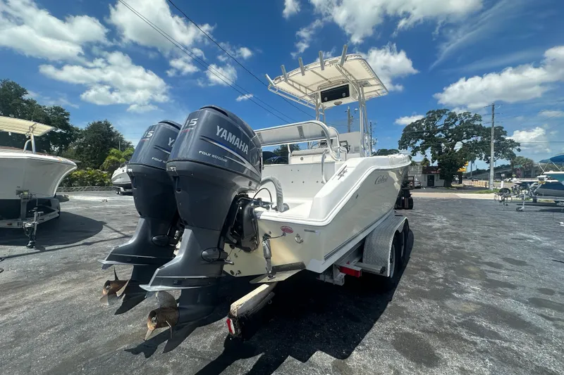 Slide: The Image of 2005 Cobia 254 Center Console boat with twin Yamaha engines on a trailer. - 5