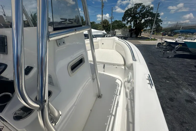 Slide: The Image of 2005 Cobia 254 Center Console boat with sleek white interior and stainless steel railings. - 20