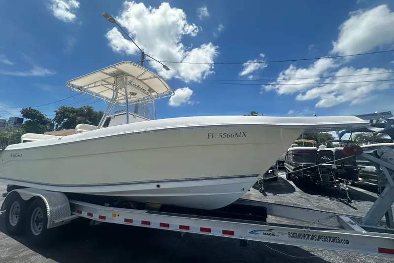 Slide: The Image of 2005 Cobia 254 Center Console boat on trailer under blue sky. - 8