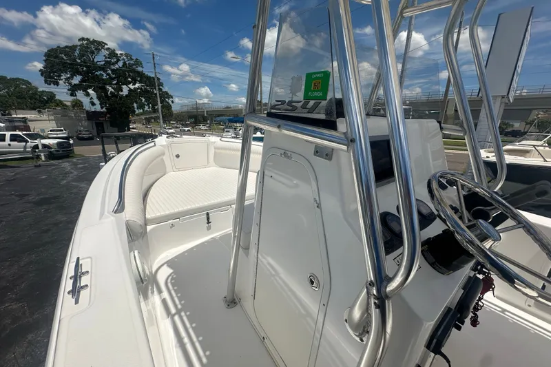 Slide: The Image of 2005 Cobia 254 Center Console boat with sleek design and spacious seating. - 19