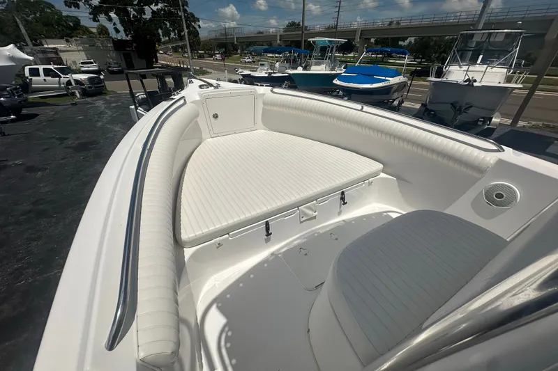 Slide: The Image of 2005 Cobia 254 Center Console boat with white seating and stainless steel railings. - 22