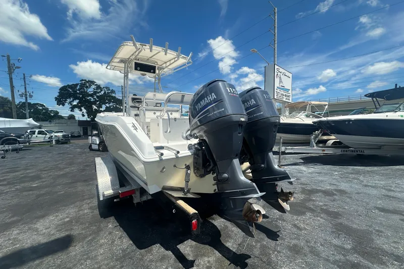 Slide: The Image of 2005 Cobia 254 Center Console boat with twin Yamaha engines on a trailer. - 3