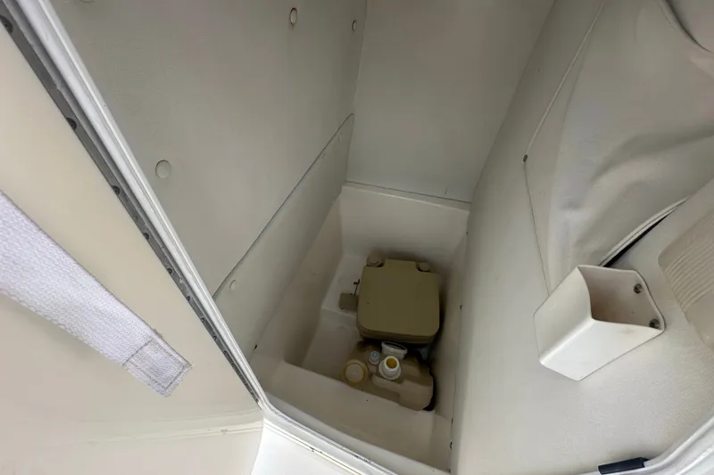 Slide: The Image of Interior view of a 2005 Cobia 254 Center Console boat's storage compartment. - 21