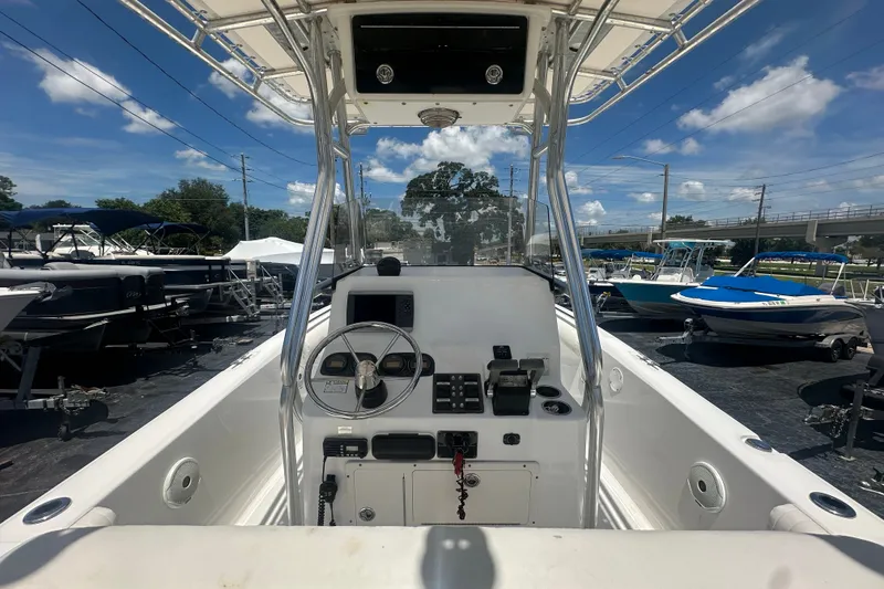 Slide: The Image of 2005 Cobia 254 Center Console boat interior with steering wheel and controls. - 16